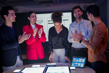 Successful creative team celebrating project achievement in modern office. Happy diverse developers...