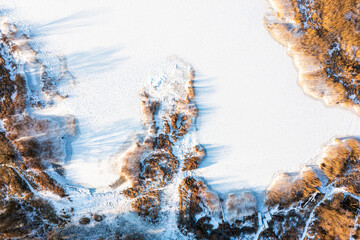 Frozen lake covered in snow, seen from a drone. Winter landscape. Lake Dabie in Poland.