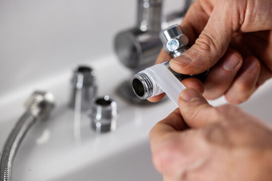 Plumber apply teflon seal tape on the plumbing fitting thread