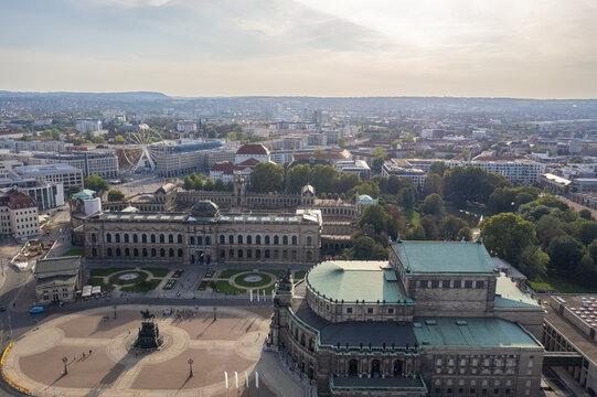 Aerial view of the Semperoper's green copper roof contrasting with the light stone facades of the Zwinger Palace and the Theaterplatz, Dresden, Saxony, Germany.