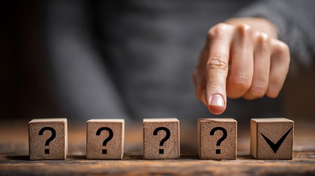 A hand pointing at a correct answer from a row of question mark blocks