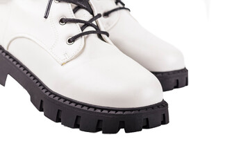 White shoes with black sole displayed on a white background for fashion retail purpose