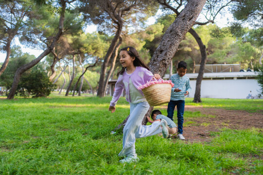 Children running, searching for eggs during an outdoor easter egg hunt