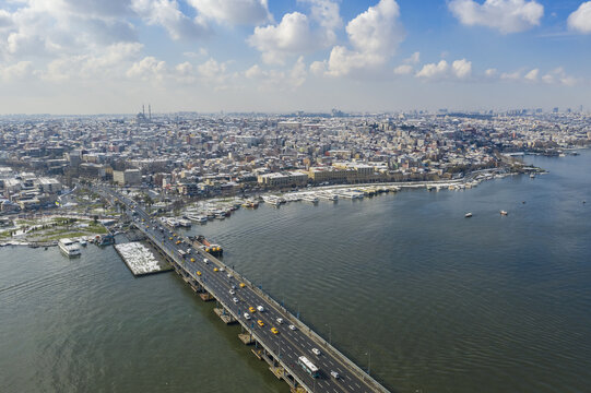 Aerial view of a bridge stretching across the blue waters, connecting the city's edges under a vast sky, Istanbul, Istanbul, Turkey.