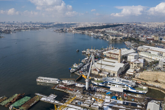 Aerial view of the Halic Shipyard, with its drydocks cradling vessels under a bright sky, Istanbul, Istanbul, Turkey.