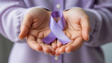 Hands gently holding a purple awareness ribbon