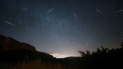 Vast night sky illuminated by countless shooting stars streaking across a dark celestial expanse over mountainous terrain