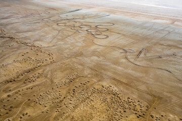 Aerial view of winding patterns etched into the stark, sandy expanse of Lake Tuz, a study in pale ochre and earthy textures, saray/van, Turkey.