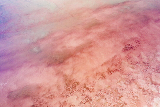 Aerial view of soft pink and purple hues blending across the textured landscape, creating an ethereal and dreamlike vista, Lake Tuz, saray/van, Turkey.