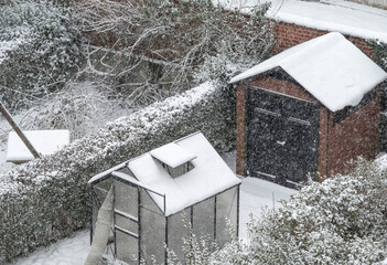 Snow-covered gardens in urban housing development
