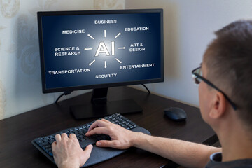 Remote work from home. Man seated at desk, focused on computer screen displaying artificial intelligence applications across diverse sectors, including business, education, and entertainment