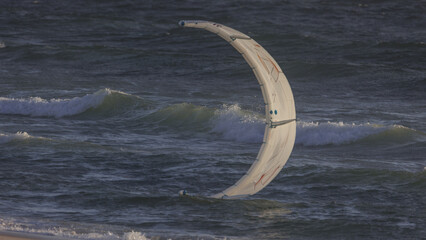 Aerial view of a kite in the ocean waves, a dance of white against the deep blue, where the horizon blurs into a dreamy seascape, Cape Town, Western Cape, South Africa.