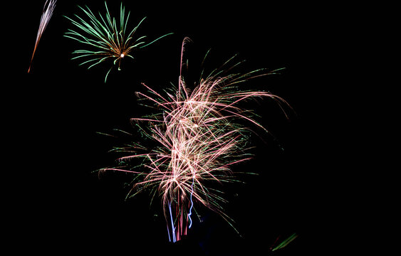 Colorful Firework Burst With Light Trails on Black Night Sky - Powered by Adobe