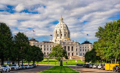 Fototapeta premium Minnesota State Capitol in Saint Paul, USA. Historic Beaux-Arts architecture features the white marble dome and golden Quadriga statue under a blue sky with clouds