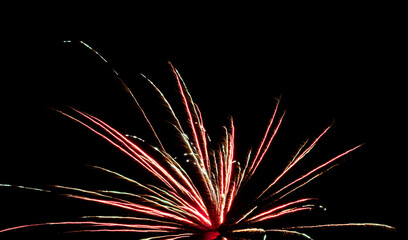 Colorful Firework Burst With Light Trails on Black Night Sky