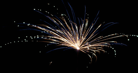 Vibrant and radiant fireworks illuminate dark sky with dazzling energy and color