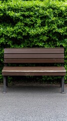 Relaxing garden area features a wooden bench and concrete table surrounded by greenery and scattered leaves for a peaceful retreat