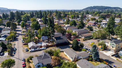 Aerial view of rooftops and tree lined streets, a tapestry of urban life seen from above in Northeast 94th Avenue, Portland, Oregon, United States.