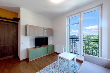 Cozy Modern Home Living Room with Natural Light Facing an Urban Balcony View