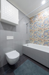Modern Bathroom With Colorful Mosaic Tiles and Compact Design Elements