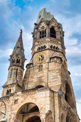 Fototapeta premium The Evangelical Lutheran church Kaiser-Wilhelm-Gedächtniskirche, colloquially known as Gedachtniskirche, is located on Breitscheidplatz. Berlin