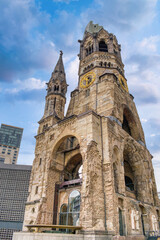 Fototapeta premium The Evangelical Lutheran church Kaiser-Wilhelm-Gedächtniskirche, colloquially known as Gedachtniskirche, is located on Breitscheidplatz. Berlin