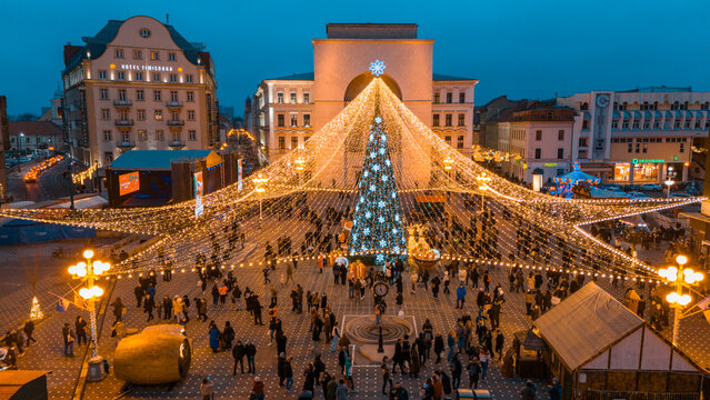Aerial view of Victory Square adorned with a towering Christmas tree amidst the Hotel Timisoara and the Romanian Orthodox Metropolitan Cathedral, Timisoara, Timis, Romania.