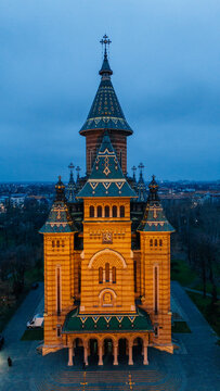Aerial view of the Timisoara Orthodox Cathedral bathed in warm light against the cool twilight, a majestic beacon in the urban landscape, Timisoara, Timis, Romania.