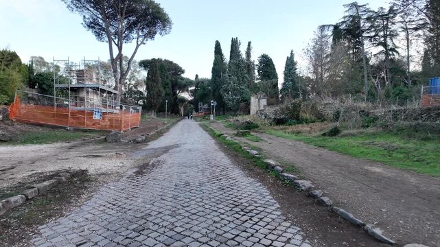 Appia Antica in Rome. Walking on the ancient Appian Way in Rome, tourist walk to discover the ruins of ancient Rome. Tourism in Italy, Grand Tour in an archaeological park