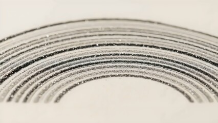 Abstract composition of graphite powder arcs forming concentric carbon whisper macro texture on dark surface