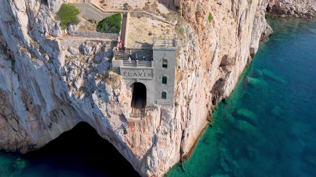  castle nestled on vertical cliffs above serene mediterranean coves near italy. Porto Flavia. 