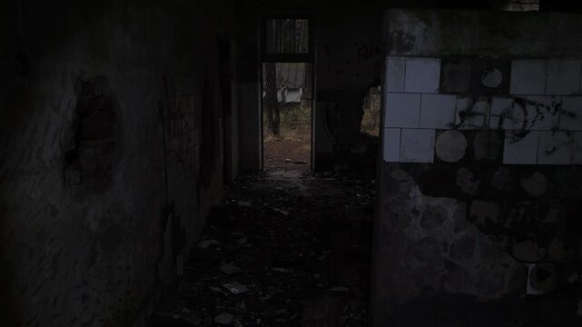burnt brick entrance into woods. ruined doorway with tiled walls, charred lintel and collapsed floor, graffiti scars on ceramic tiles, view through hole to forest clearing salvage crew