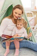 Young mother reading to her toddler child
