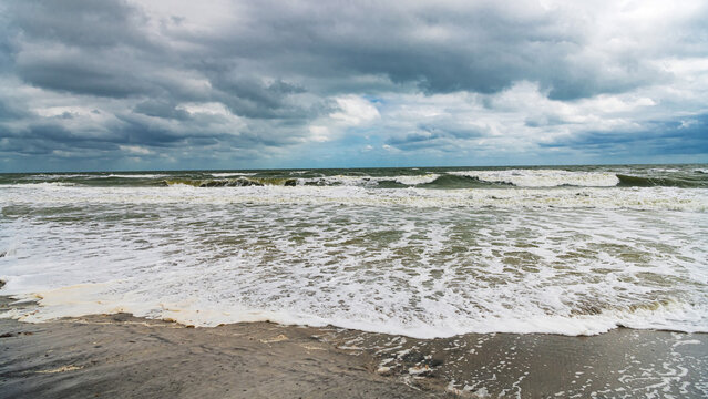 Stormy beach in Florida with rough waves and empty shoreline