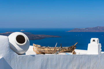 Old shipwreck boat on top of a white washed building in Fira, Santorini, Greece