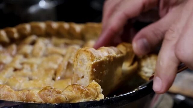 Using a knife to slice a freshly baked apple pie.