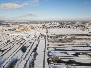 heavy snowfall in the Netherlands covers fields in polder and causes disruption in residential areas with closed roads. Drone footage of winter weather snow scene beautiful landscape  