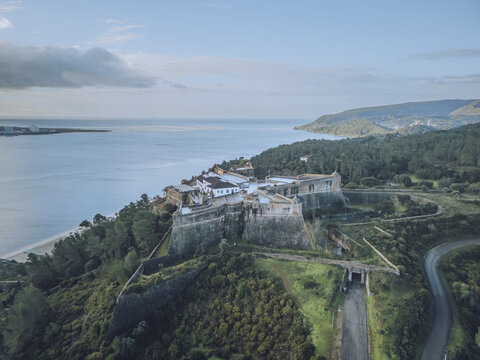 Aerial view of the historic Forte de Sao Filipe standing proudly against the azure coastline, a testament to time overlooking the serene waters, Setubal, Setubal, Portugal.