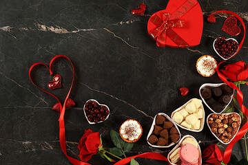 Gourmet heart shaped chocolate candies, sugar cranberry, meringue and rose flowers, food for Valentine's Day or Women's Day, greeting card, advertising banner or store invitation, selective focus.