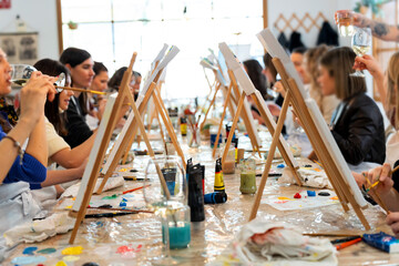 Women enjoying sip and paint art workshop