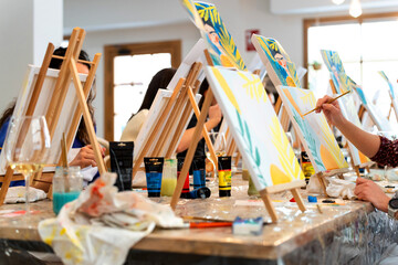 Women enjoying sip and paint art workshop