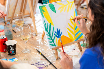 Woman enjoying sip and paint art workshop