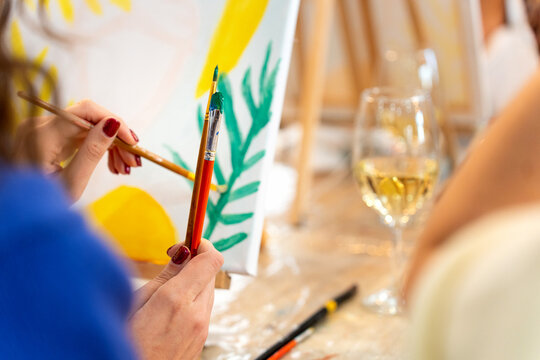 Women enjoying sip and paint art class activity