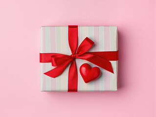 &ldquo;Valentine&rsquo;s Day gift box with red ribbon and heart decoration, pastel background, soft studio lighting, top-down flat lay, minimal clean composition, copy space.&rdquo;                                    