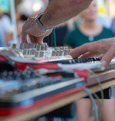 Sound Engineer Adjusting Audio Mixer at Live Outdoor Event