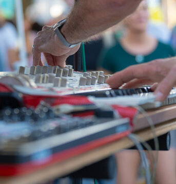 Sound Engineer Adjusting Audio Mixer at Live Outdoor Event