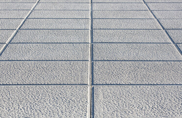 New carved paving made with chiseled grey sandstone blocks in a pedestrian zone