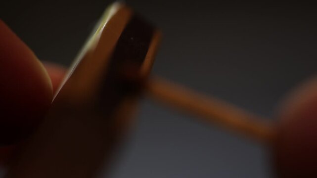 An extreme macro video of a match being struck against the side of a matchbox. 
