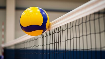 Vibrant yellow and blue volleyball caught in a taut net during an intense indoor game, symbolizing