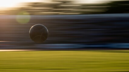 Dynamic motion blur captures a basketball soaring across an athletic court at sunset, highlighting